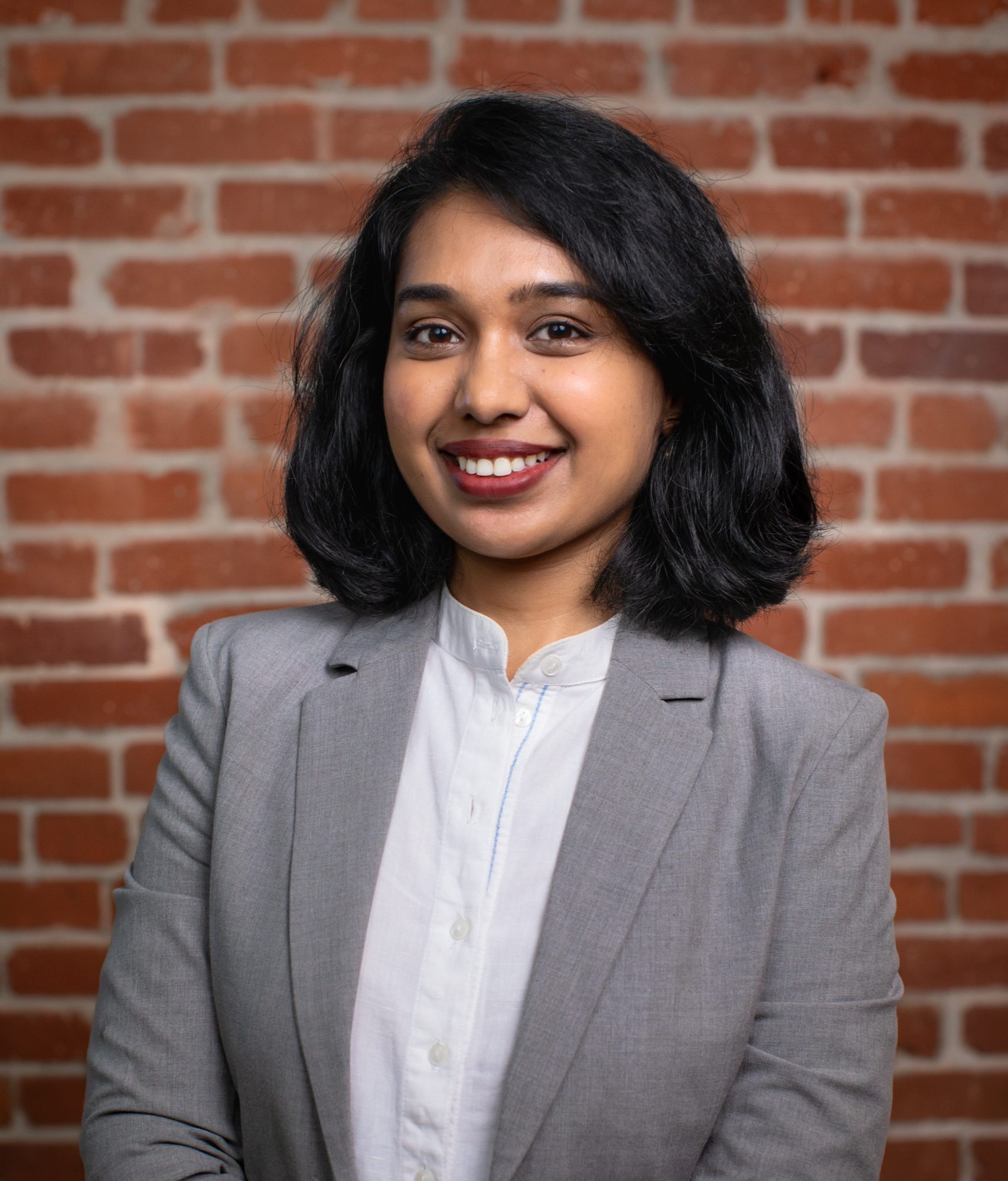 Portrait of Sai Amulya Nyathikala smiling in front of a brick wall, associated with Climate Resolve