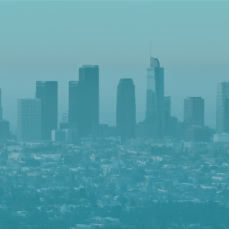 Los Angeles skyline viewed from a distance with a teal overlay, showing downtown buildings rising above a dense urban landscape