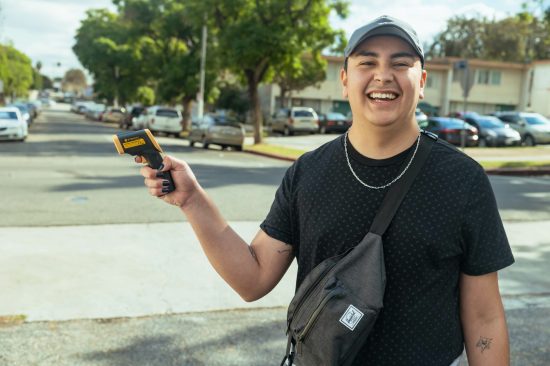 Person holding up digital temperature reader.